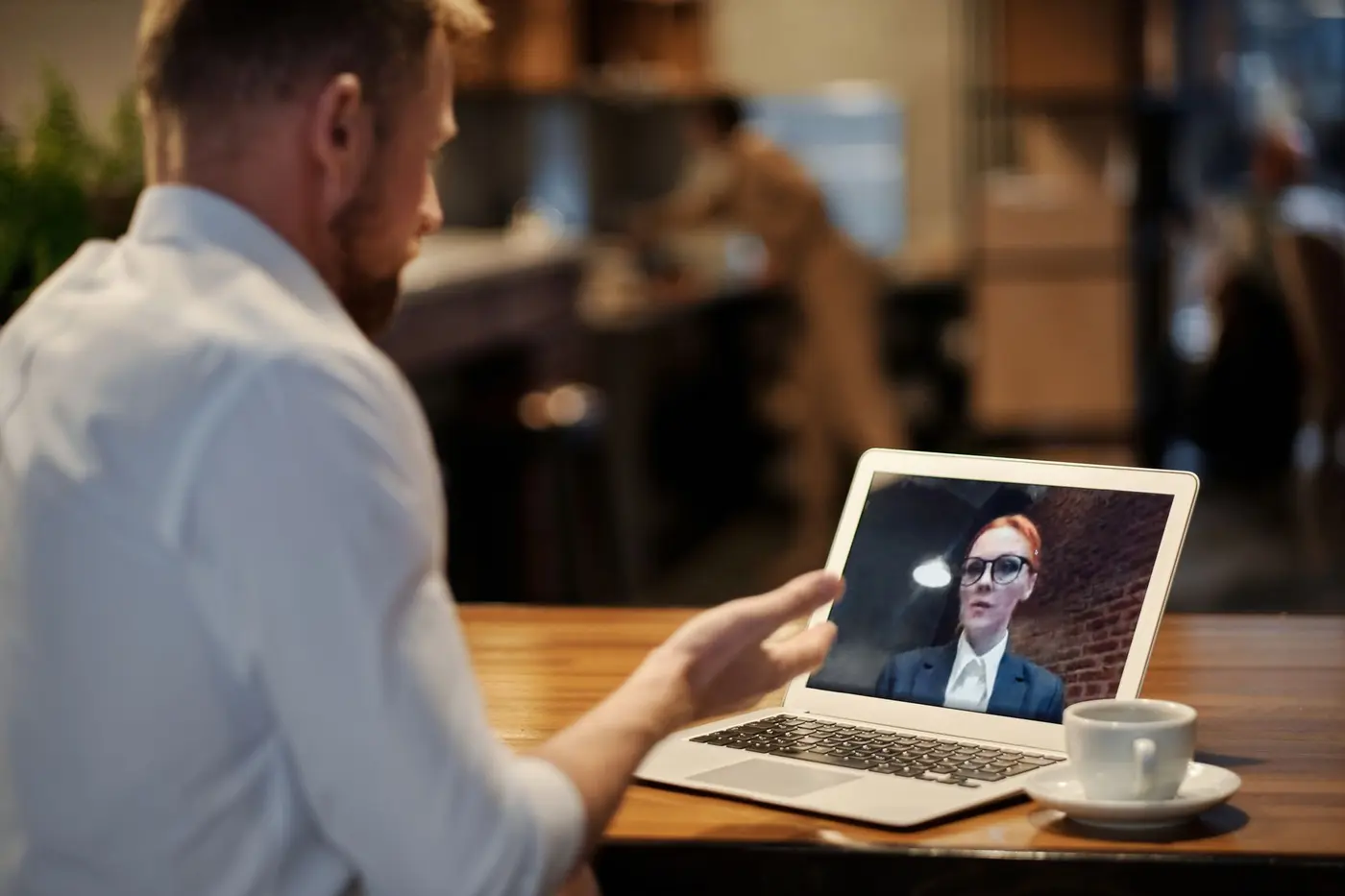 A consultation being taken over a laptop from a remote workspace